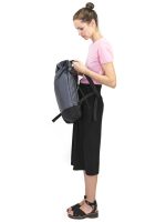 A young woman in a pink shirt is holding the Braasi Basic Side rolltop backpack, made with high quality materials from Europe.