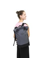 A smiling woman is wearing a gray Braasi Basic Side over one shoulder, with the top rolled down and closed on the sides.