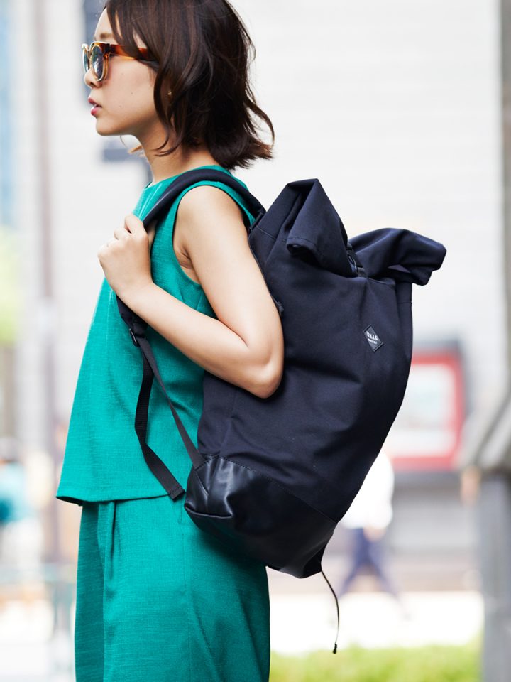 Woman wearing the Braasi NOIR backpack in full black, which has a simplistic design and goes with everything.