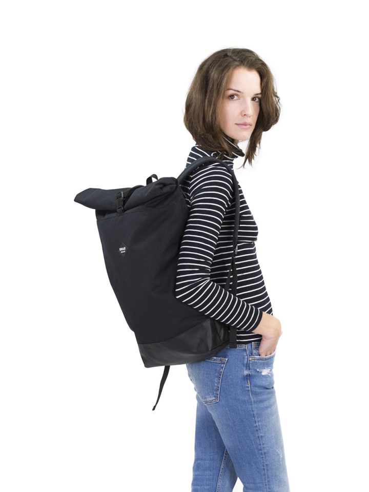 A Model wearing the Braasi Noir rolltop, a stylish and practical backpack made in Europe.